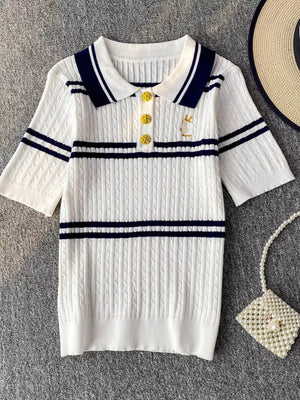 White cable knit polo shirt with navy stripes and gold buttons
