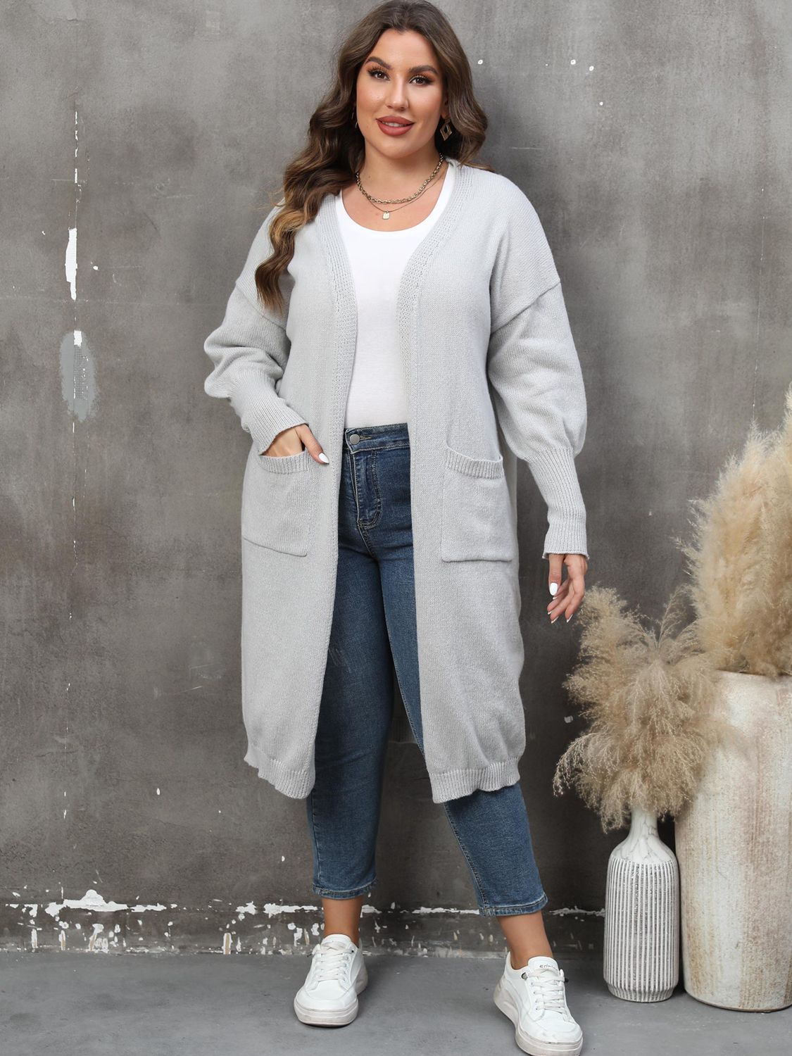 Light gray oversized knit duster cardigan with patch pockets and a long length.