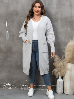 Light gray oversized knit duster cardigan with patch pockets and a long length.