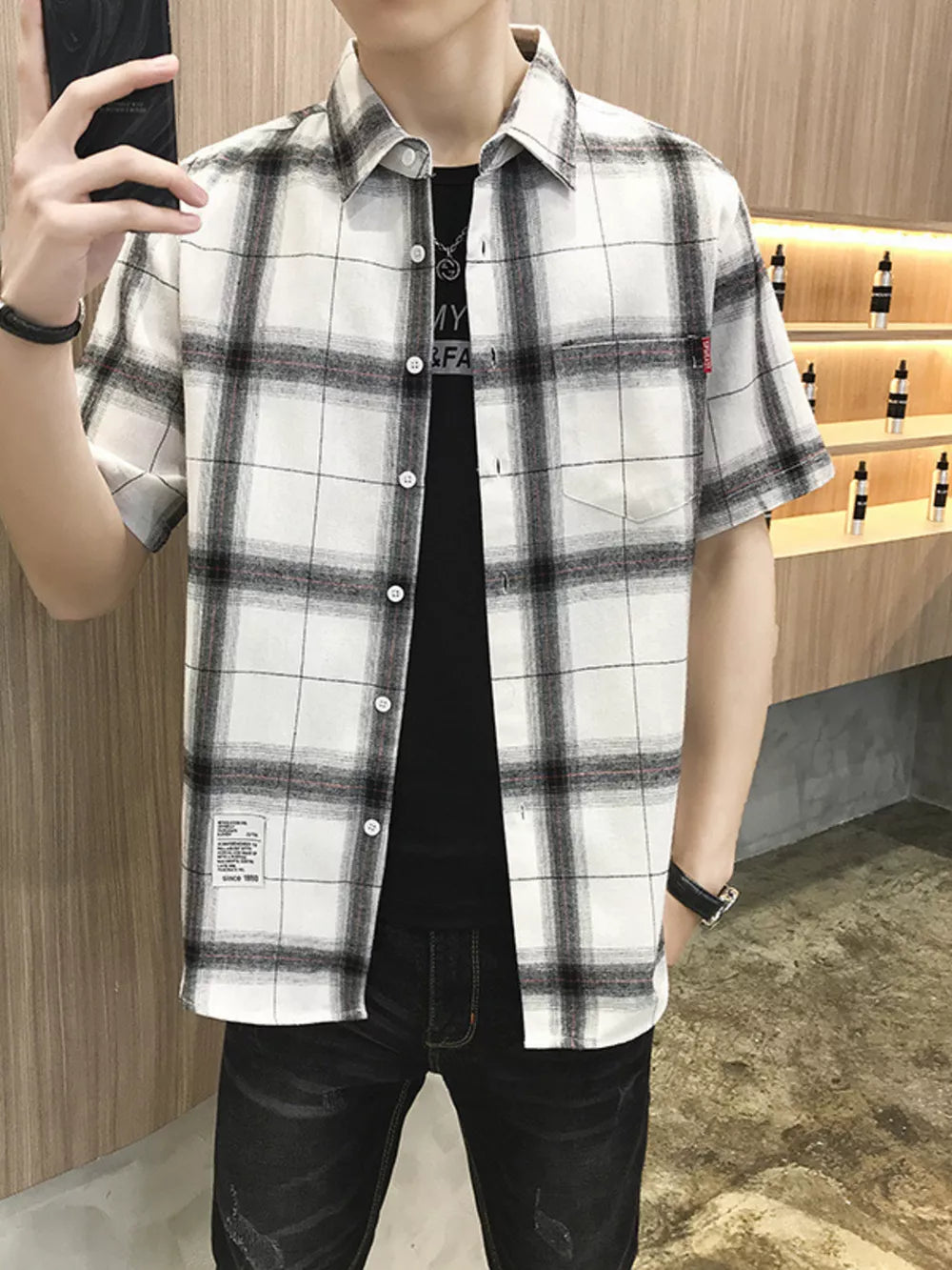 Classic oversized plaid short sleeve button-down shirt in white with black and red plaid.