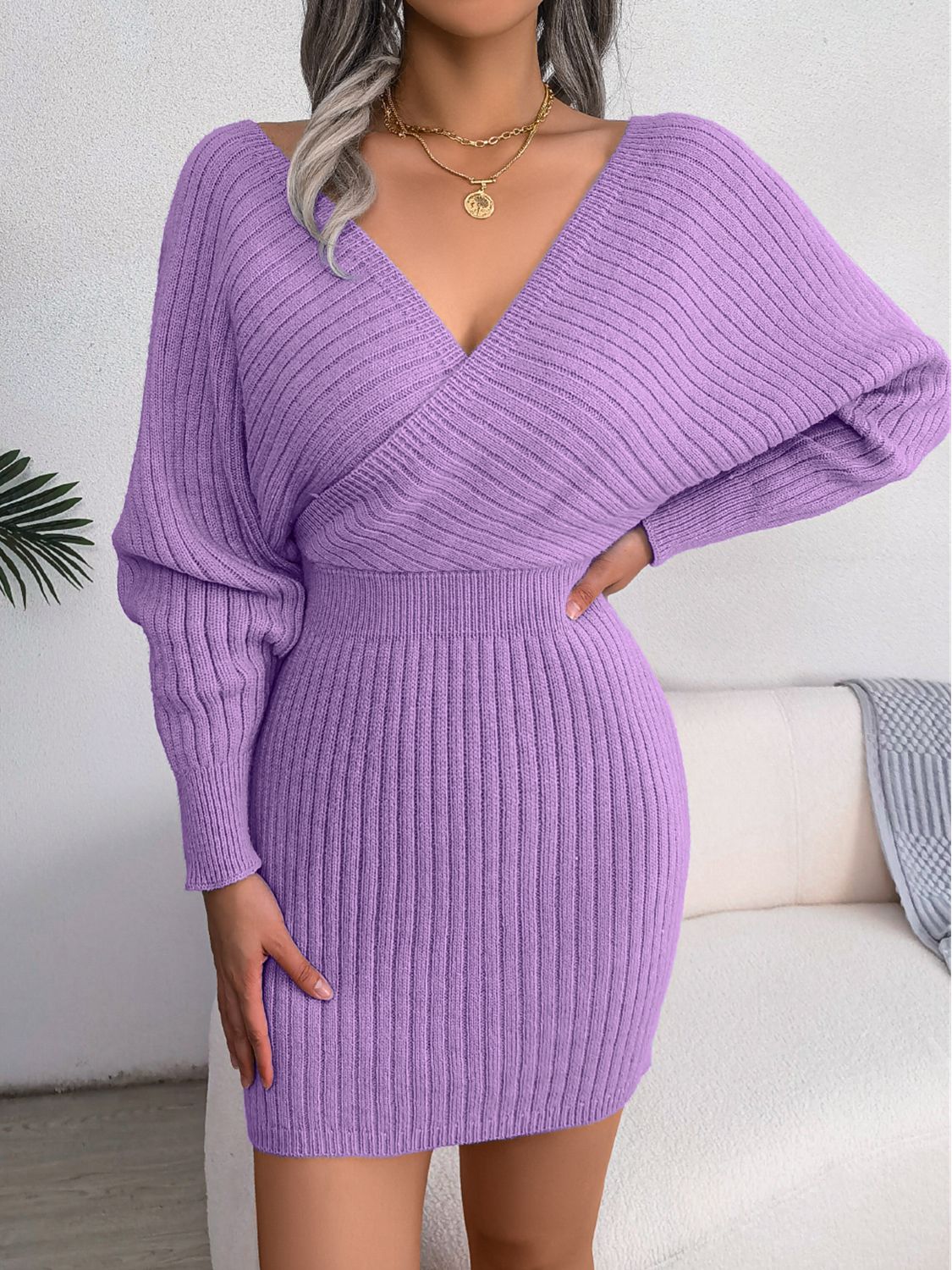 Wrap knit bodycon mini dress in heliotrope purple with a deep V-neck and long dolman sleeves.