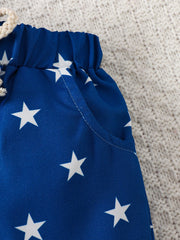 Blue cotton baby shorts with white stars and drawstring waist.