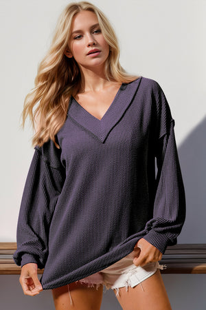 Purple waffle knit collar top with V-neck and long sleeves.