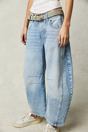 Light blue denim barrel leg jeans with knee panel detail and a woven belt.