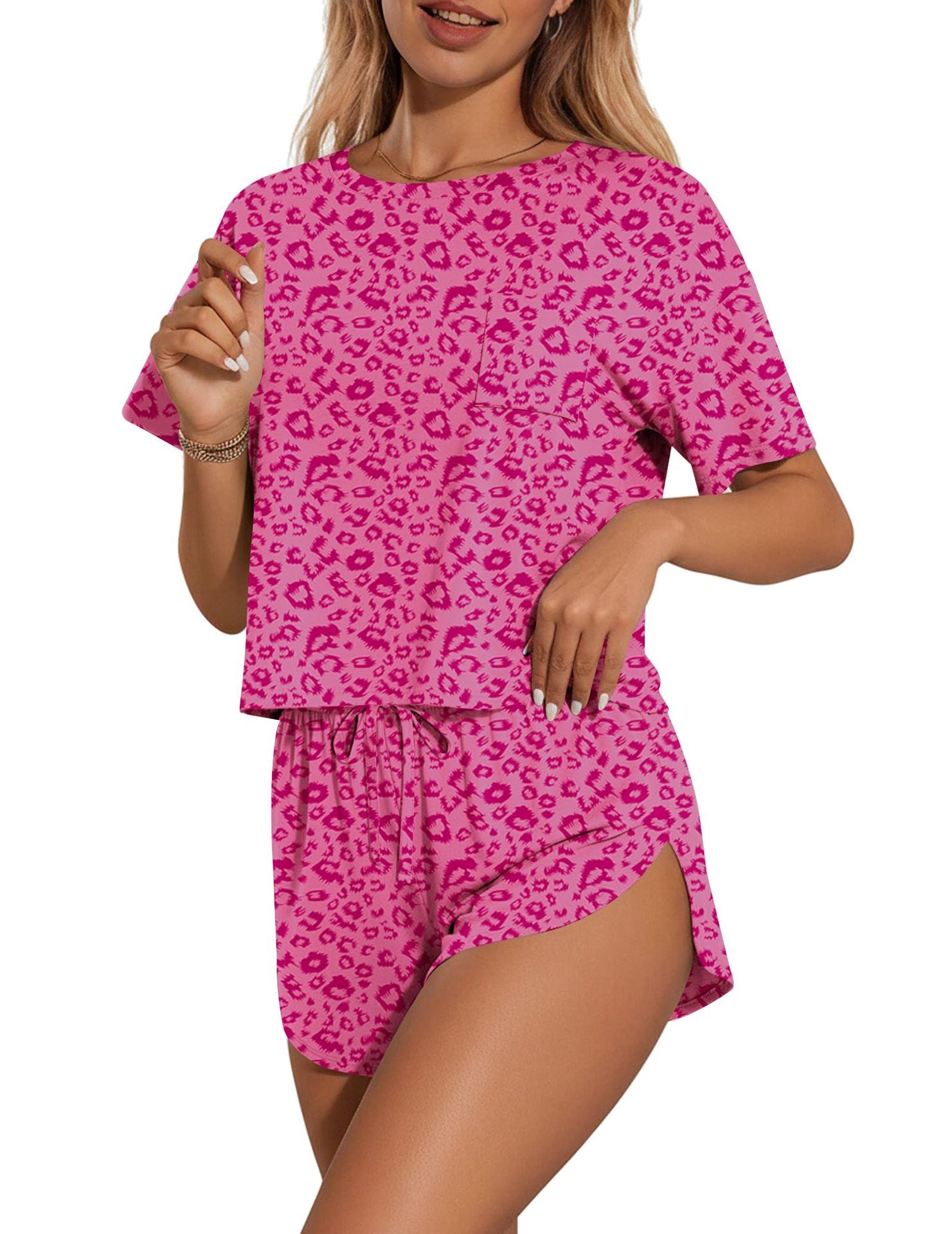Pink leopard print pajama set with drawstring shorts and short sleeve top.