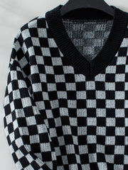 Checkerboard knit v-neck pullover sweater in black and white.