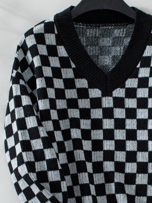 Checkerboard knit v-neck pullover sweater in black and white.