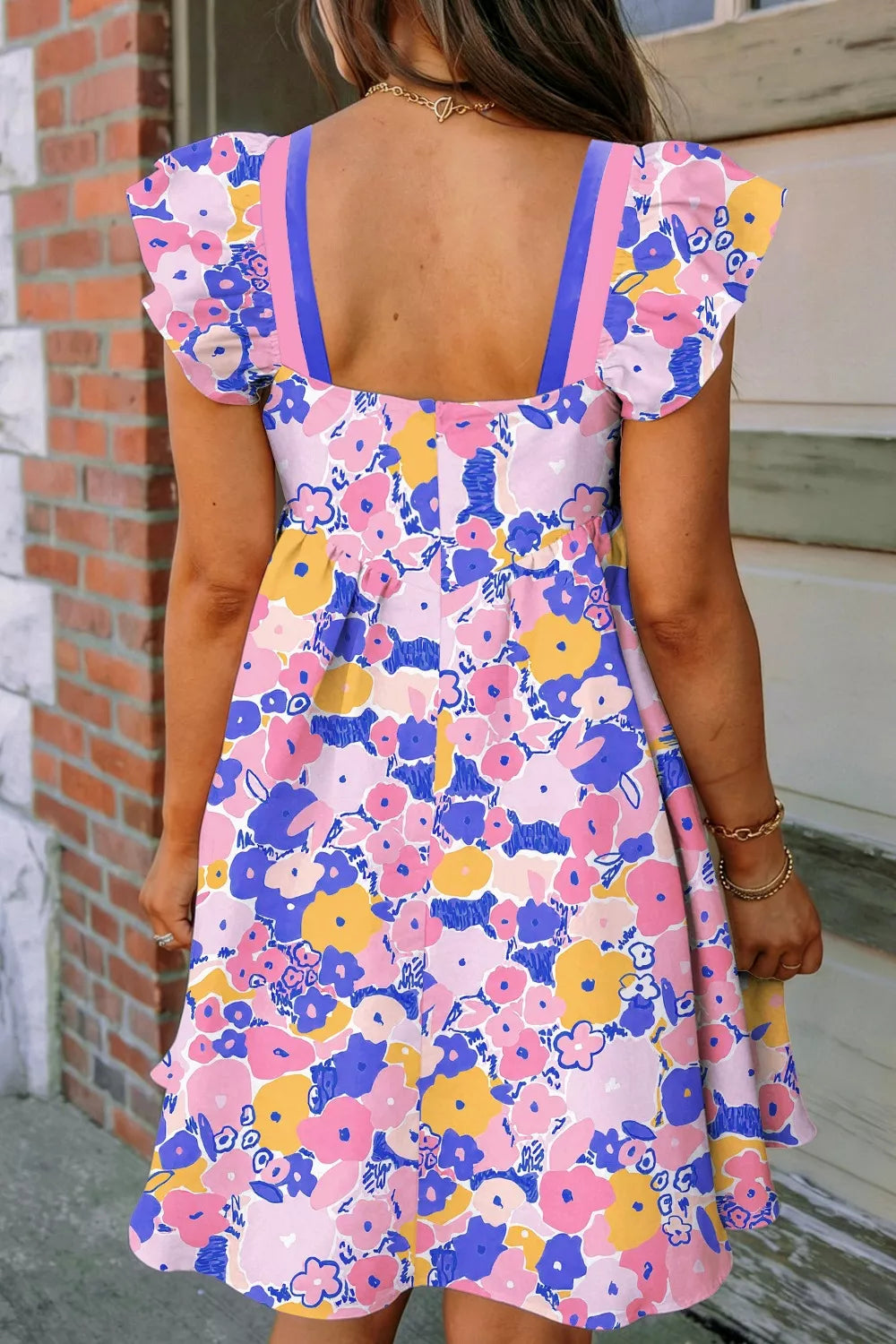 Floral flutter sleeve mini dress with square neck and pink, blue, yellow floral print.
