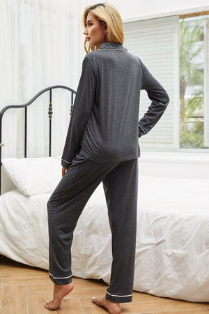 Gray pajama set with contrast piping, long sleeves, and pants.