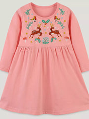 Pink cotton dress with embroidered deer, birds, holly, and mushrooms.