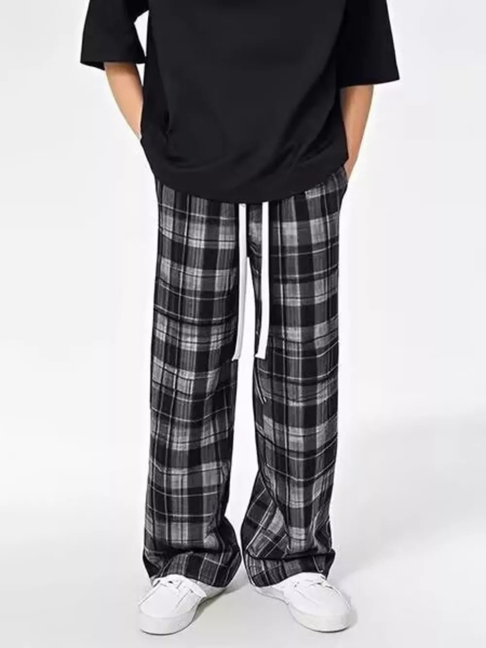 Plaid drawstring sweatpants in black and grey with a relaxed fit.