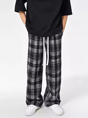 Plaid drawstring sweatpants in black and grey with a relaxed fit.