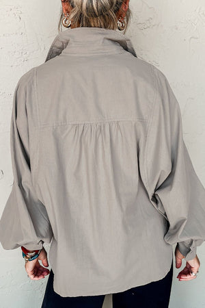 Light gray balloon sleeve button-down blouse with gathered back detail.