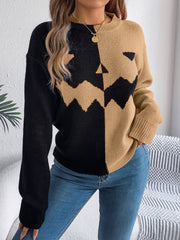 Split-face pumpkin knit sweater in black and camel with crew neck and long sleeves.