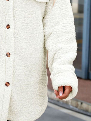 White teddy shacket with button front and textured fabric.