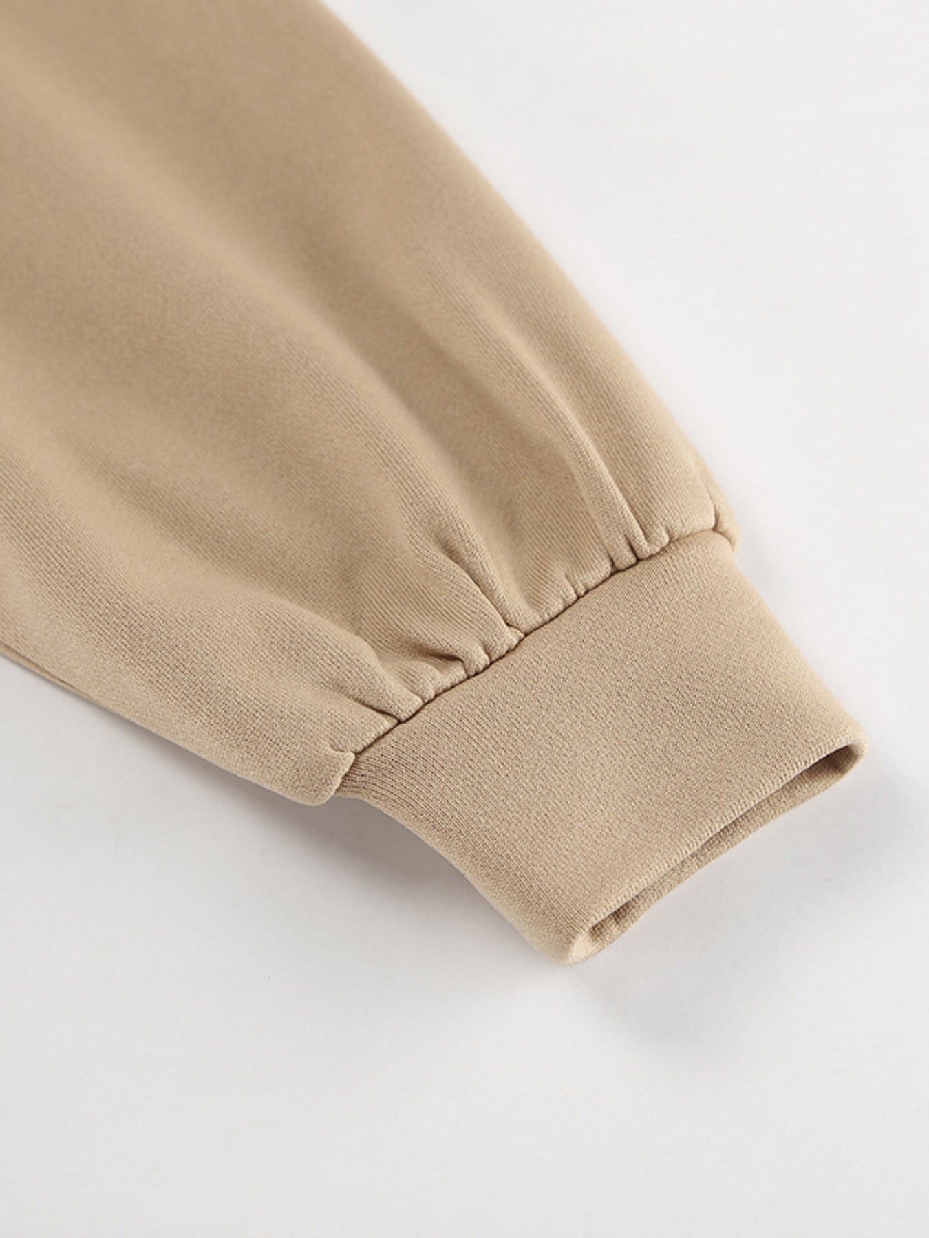 Camel quarter zip top sleeve detail with ribbed cuff and gathered fabric