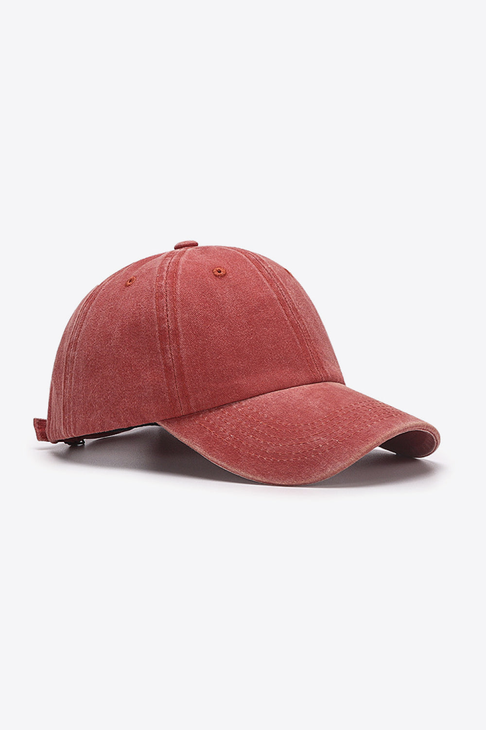 Washed cotton baseball cap in red with adjustable strap detail.