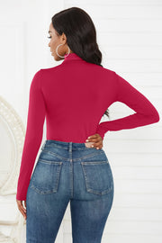 Burgundy turtleneck thong bodysuit with long sleeves, styled with denim jeans.