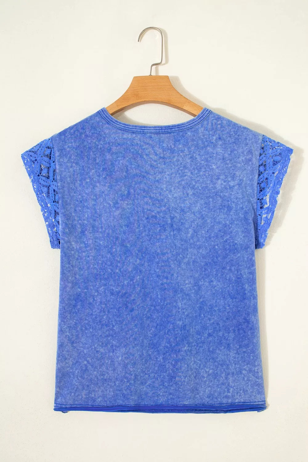 Blue mineral wash cotton tee with lace cap sleeves and distressed details.