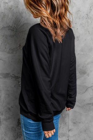 Black crewneck sweatshirt with long sleeves and ribbed cuffs.