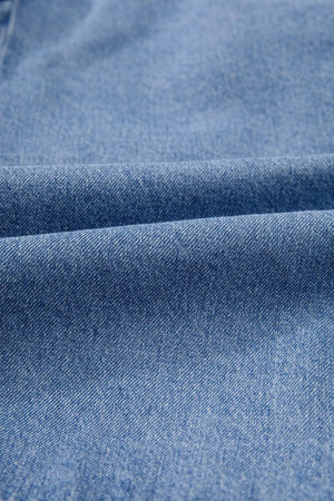 Denim bow-tie peplum blouse in medium wash denim fabric with a textured weave.