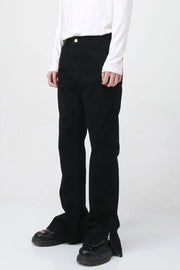 Flared hem denim trousers in dark cotton with zip detail at the ankle.