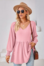 Textured pink babydoll blouse with V-neck and smocked cuffs