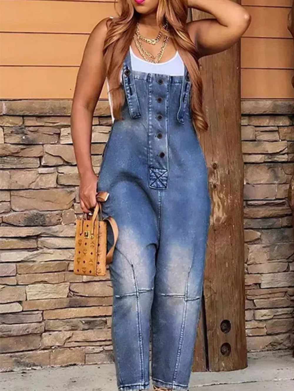 Denim overalls with button-front and adjustable straps in dirty blue wash.
