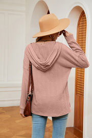 Textured henley hoodie in coral with drop shoulder and long sleeves.