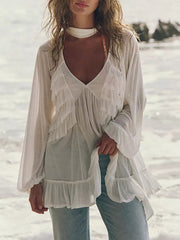 White sheer ruffle trim beach cover-up with V-neck and long sleeves.