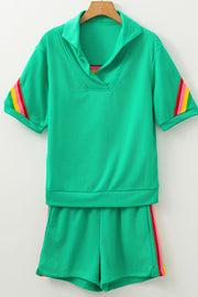 Green activewear shorts and top set with rainbow stripe details on sleeves and shorts.