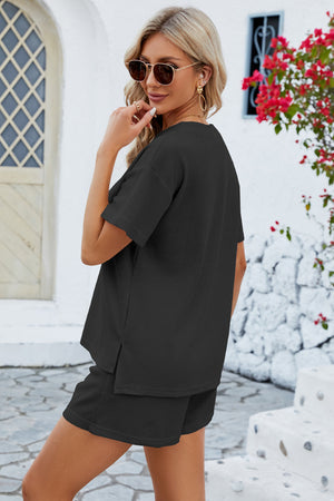 Black waffle knit henley short set with short sleeves and side slits on top.