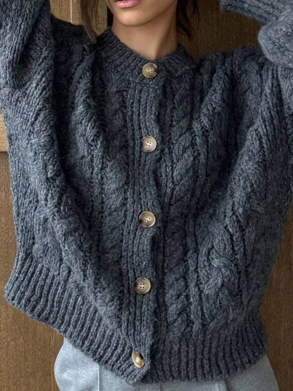 Gray cable-knit button-down cardigan with wooden buttons.