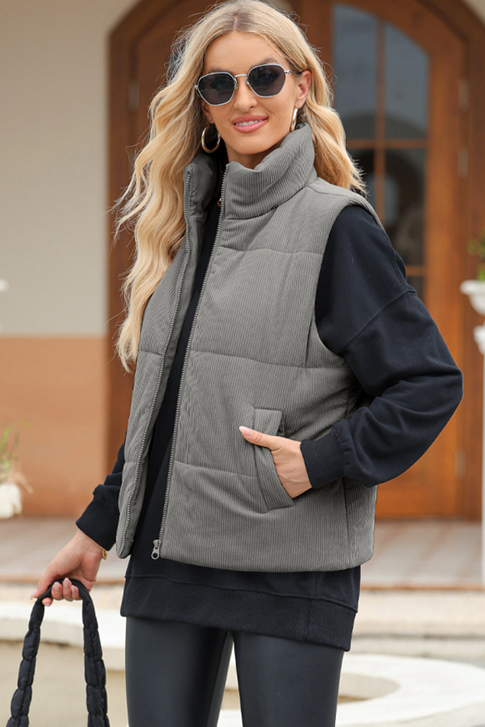 Corduroy funnel neck puffer vest in Dark Gray with zip front and pockets.