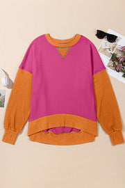 Chic Contrast Crewneck Sweatshirt in pink and orange with contrast stitching and raw hem.