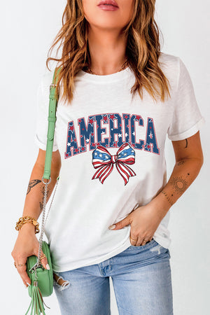 White graphic tee with "AMERICA" text and a patriotic bow motif.
