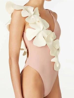 Pale Blush one-shoulder swimsuit with sculptural petal detailing on the strap and side.