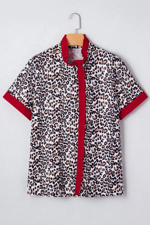 Leopard print polyester shirt with red frill detail, V-neck, and short sleeves.
