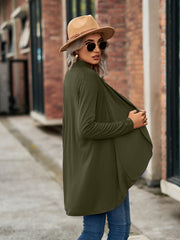Moss green draped cascade cardigan with long sleeves and open front, styled with jeans and a hat.