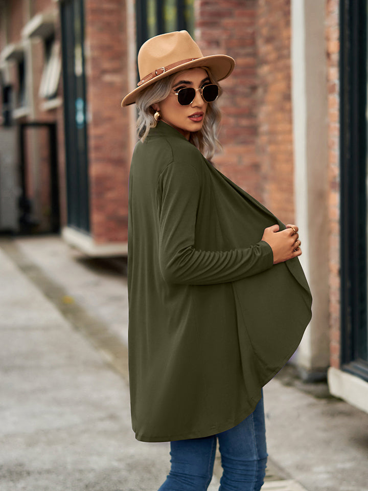 Moss green draped cascade cardigan with long sleeves and open front, styled with jeans and a hat.