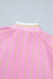 Pink striped polo shirt with a white and green striped collar detail.
