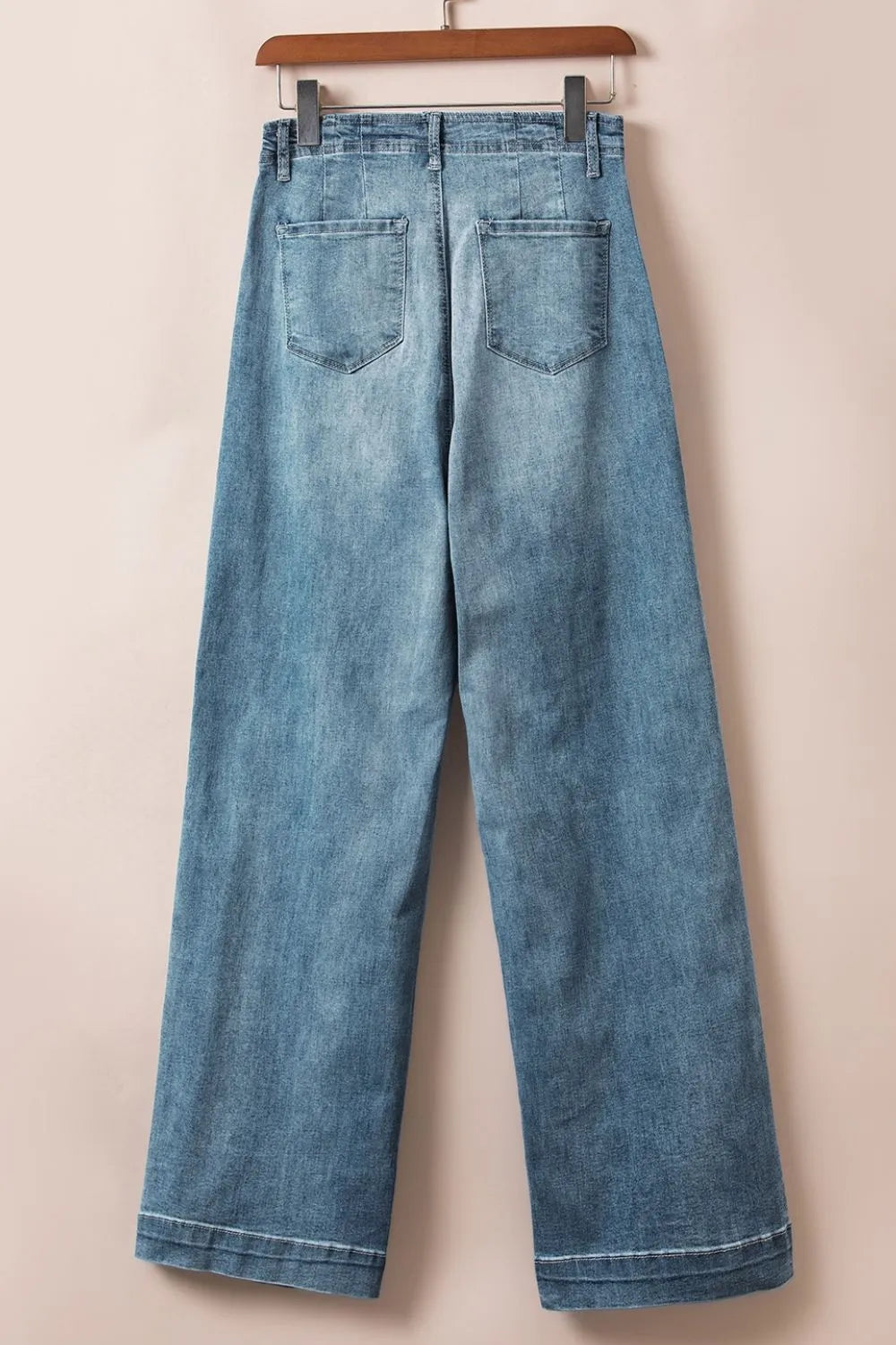 Button-fly wide-leg denim trousers in medium wash with two back pockets and a clean hem.