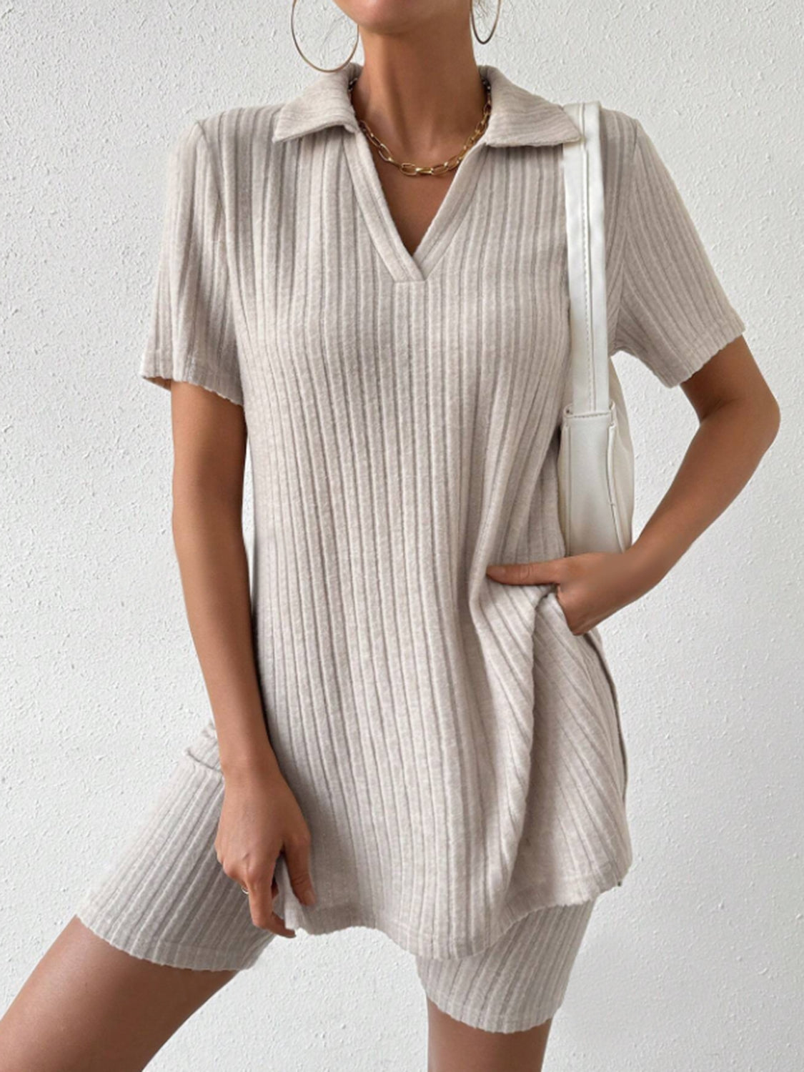 Textured ribbed polo shirt and shorts co-ord set in tan, with a v-neck and short sleeves.