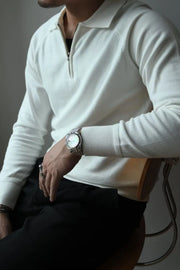 Ivory knit polo with zip-through neckline and raglan sleeves.