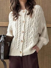 Ivory cable-knit button-down cardigan with wooden buttons.