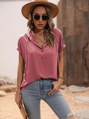 Relaxed dusty pink henley hoodie with rolled sleeves and button placket.