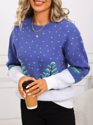 Blue acrylic sweater with white polka dots and evergreen tree graphic, color block sleeves.