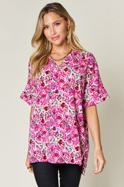 Floral ikat relaxed v-neck top in pink with short sleeves and a relaxed fit.