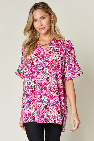 Floral ikat relaxed v-neck top in pink with short sleeves and a relaxed fit.