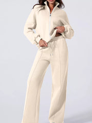 Beige cotton zip-up jacket and drawstring pants set with seam detail.